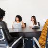 4 women sitting around a table