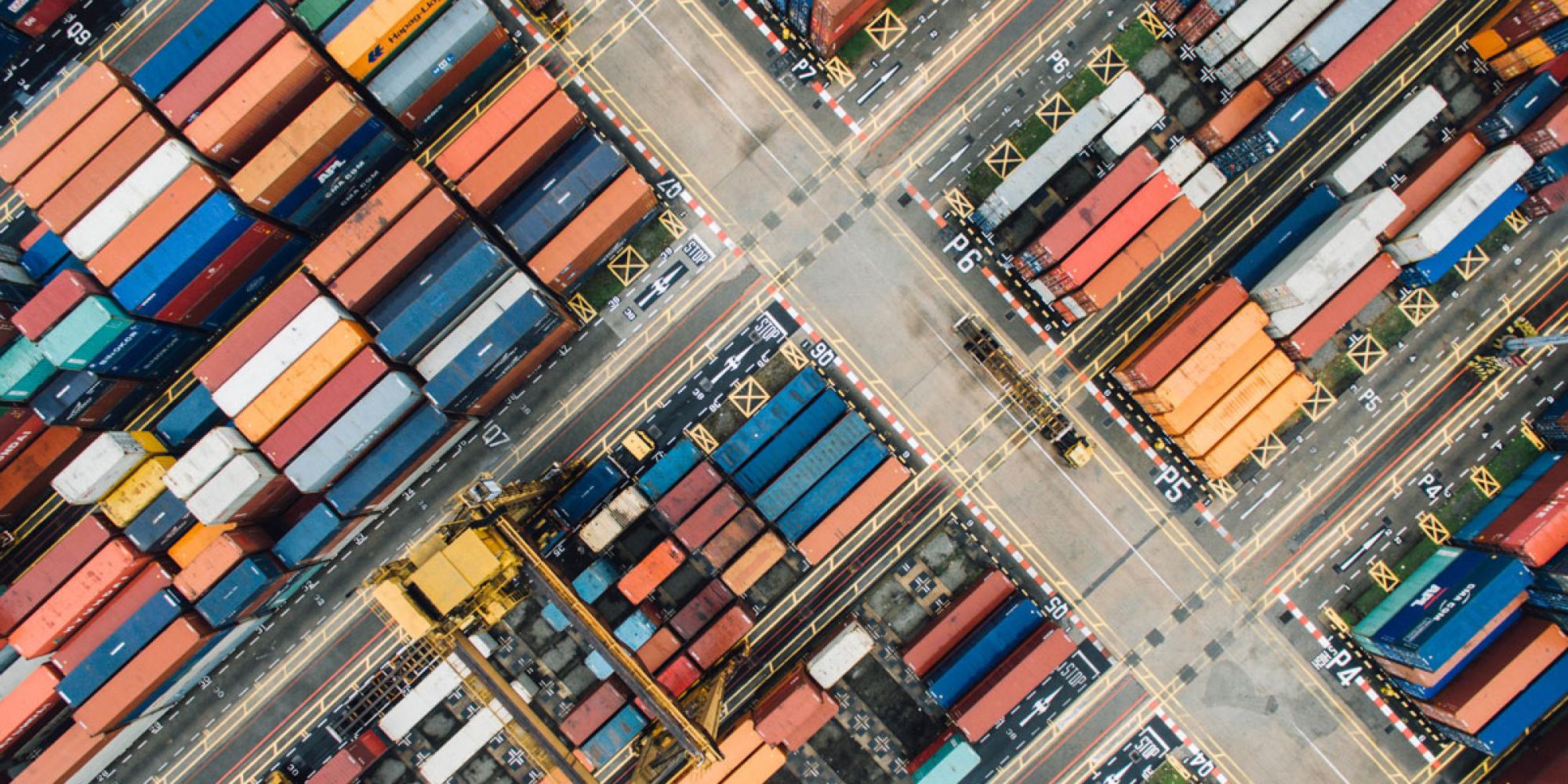 Containers sitting at a port seen from above.