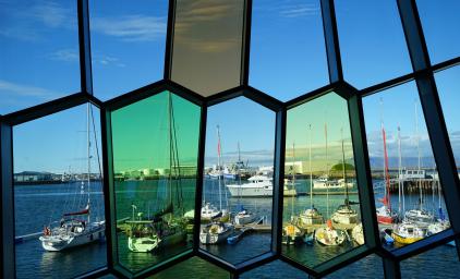 View of a harbor in Reykjavik from inside a building with colored glass