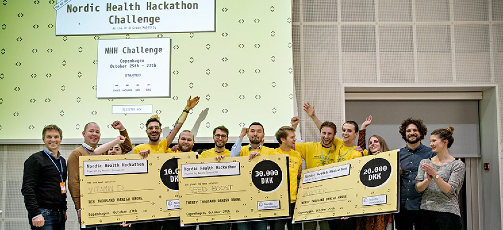 Group of people cheering and holding prize checks