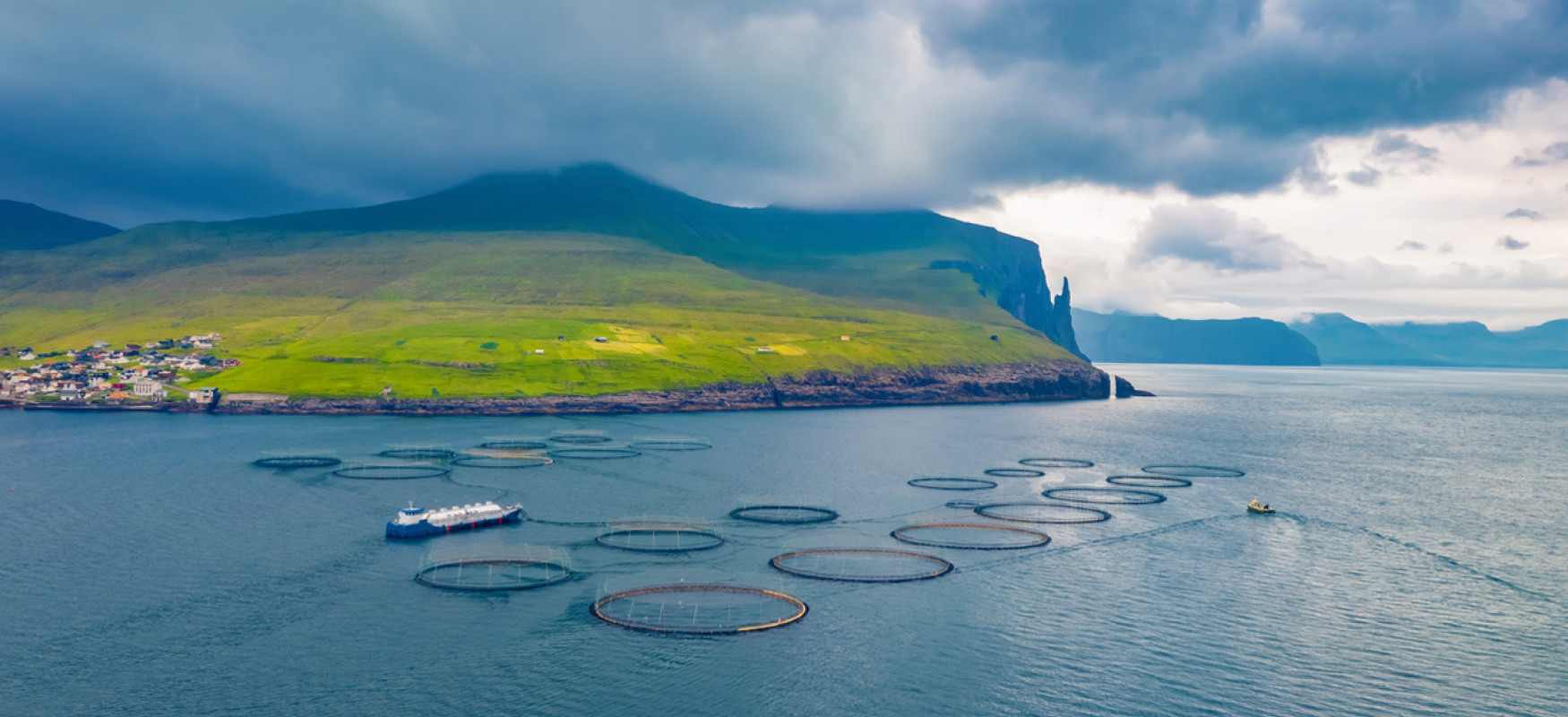 Fish farm on outskirts of Sandavagur village, Faroe Islands