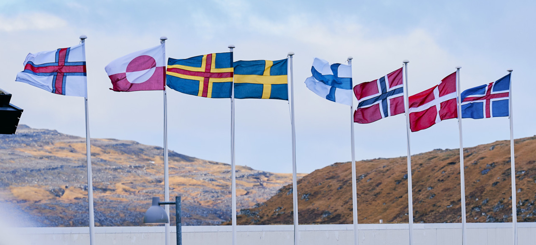 All the Nordic flags flying in the wind on flagpoles