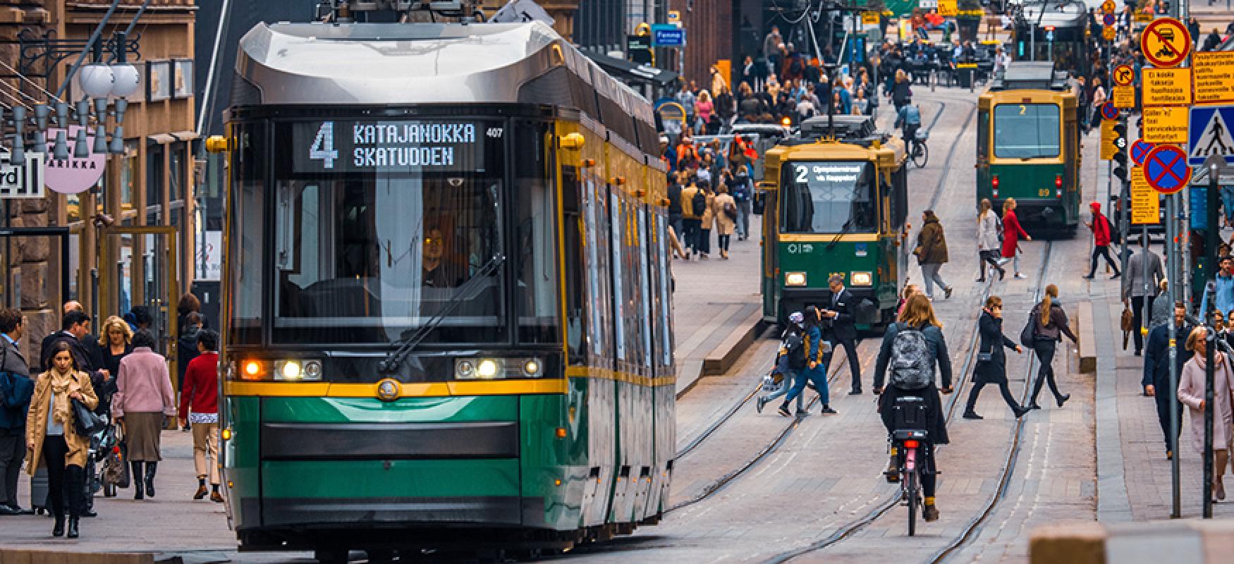 Trams and bikers in a city centrum. 
