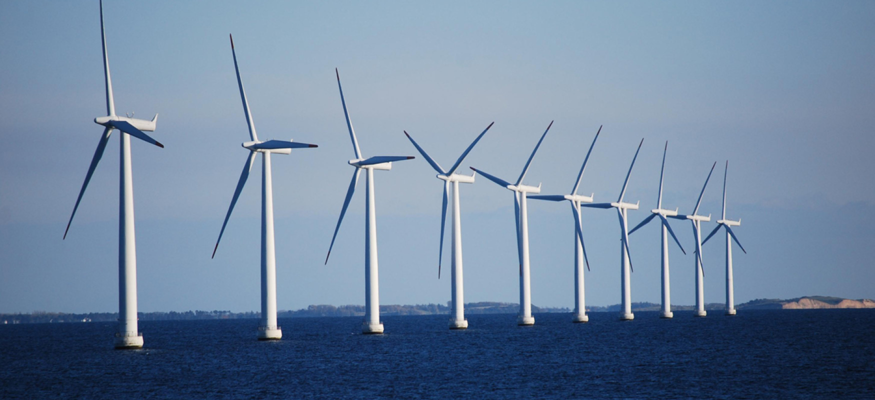 A row of 10 wind turbines standing in the sea